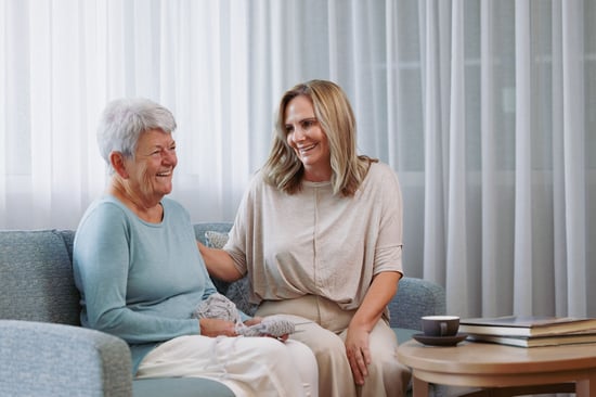 An older couple seeking residential aged care in miranda with a healthcare professional at an aged care home in the Sutherland Shire.