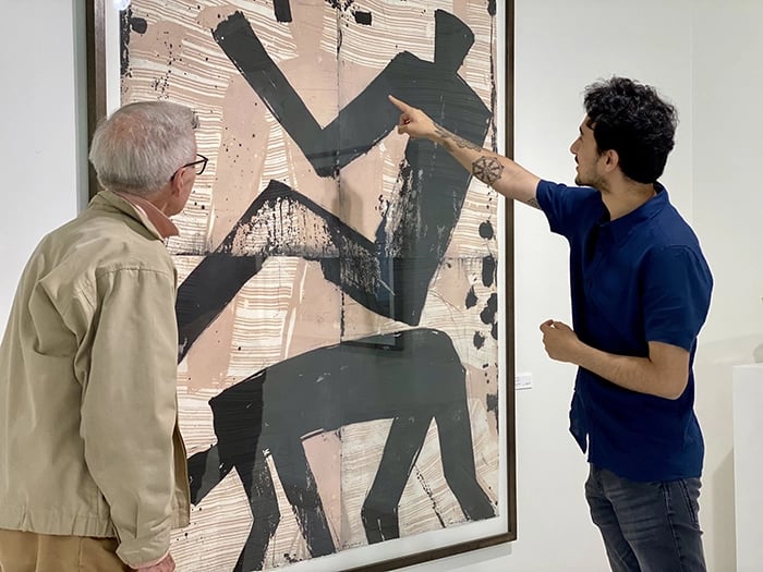 John Bush (left) with Prajdnik Awashi with a Graham Fransella artwork at the Beaver Galleries, Deakin