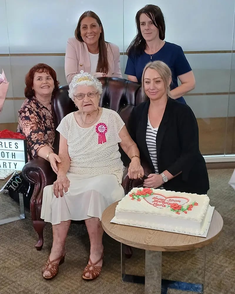 Merle Simon celebrates her birthday with HammondCare Home Care GM Marcela Carrasco (top left) and other members of the care team