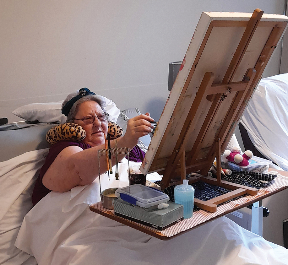 Sandra painting in bed