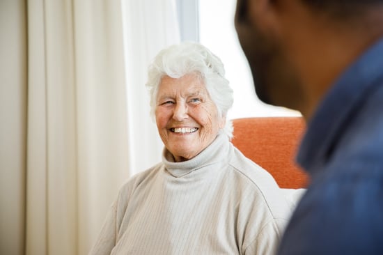 An older man and a carer enjoy a walk in the garden at HammondCare Hammondville, an aged care home in South Sydney, NSW.