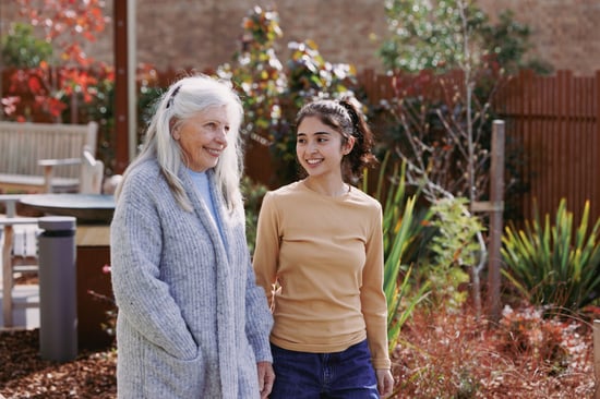 An older woman and a carer enjoy a stroll in the garden at HammondCare Strathearn House, an aged care home in the Upper Hunter Valley, NSW.